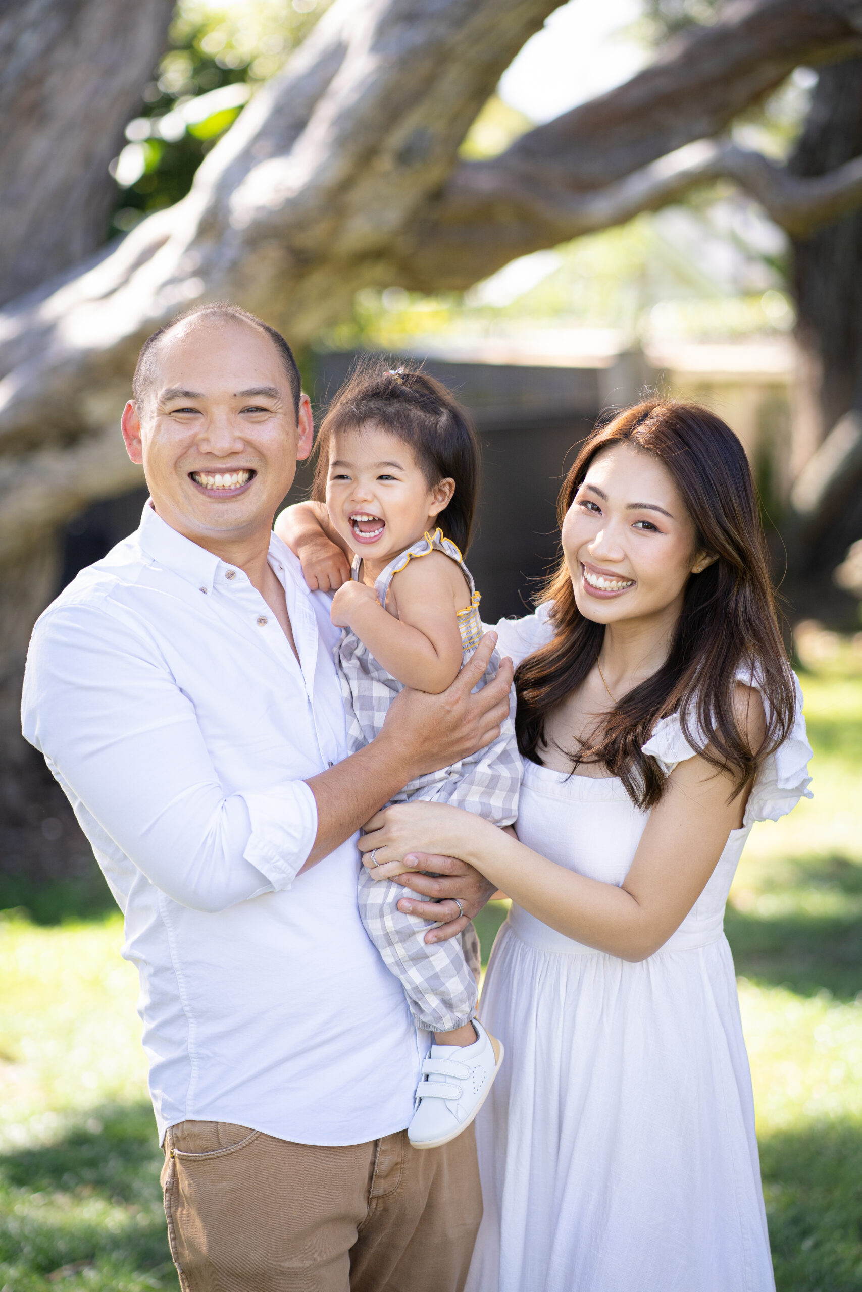 Family smiles in a beautiful Wanaka setting for their family photoshoot